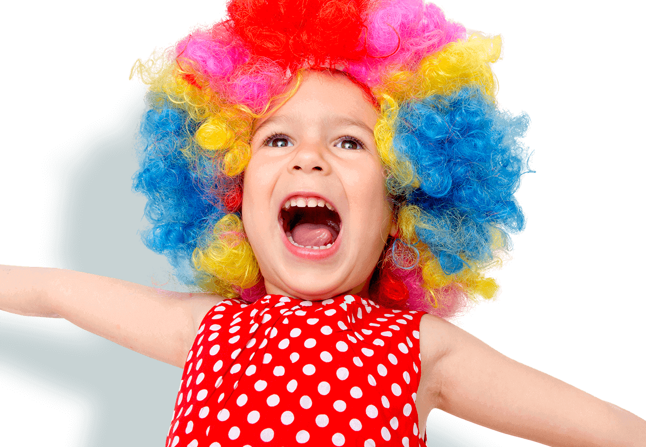 kids klubs gallery page banner photo of girl singing with arms out and wearing a multi-coloured wig